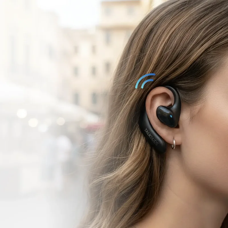 Close-up of a Talkbuds earbud worn on the ear with the open-ear hook